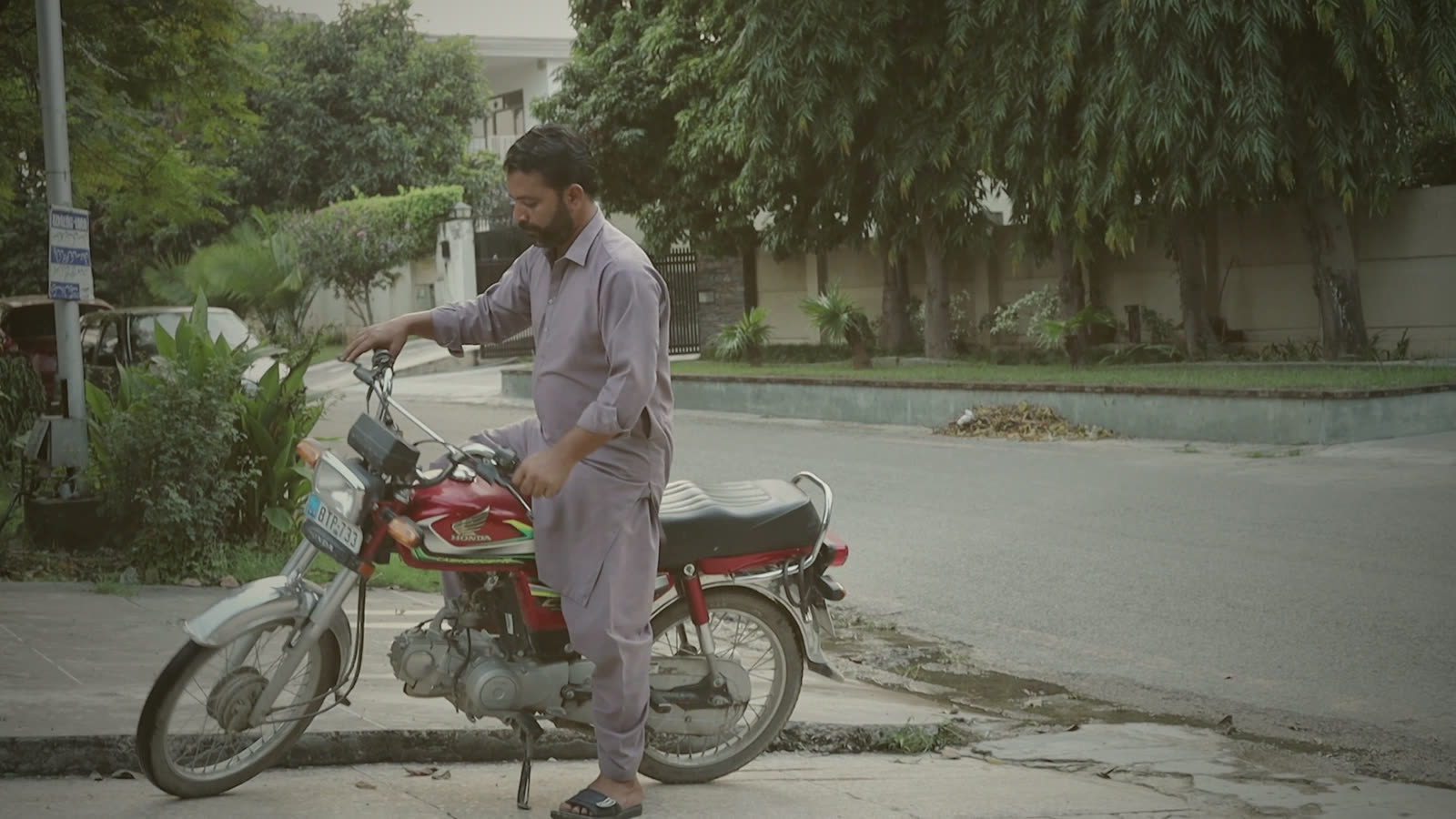 Zulqarnain Haider stopped on his motorbike on a tree-lined Islamabad street, one foot down